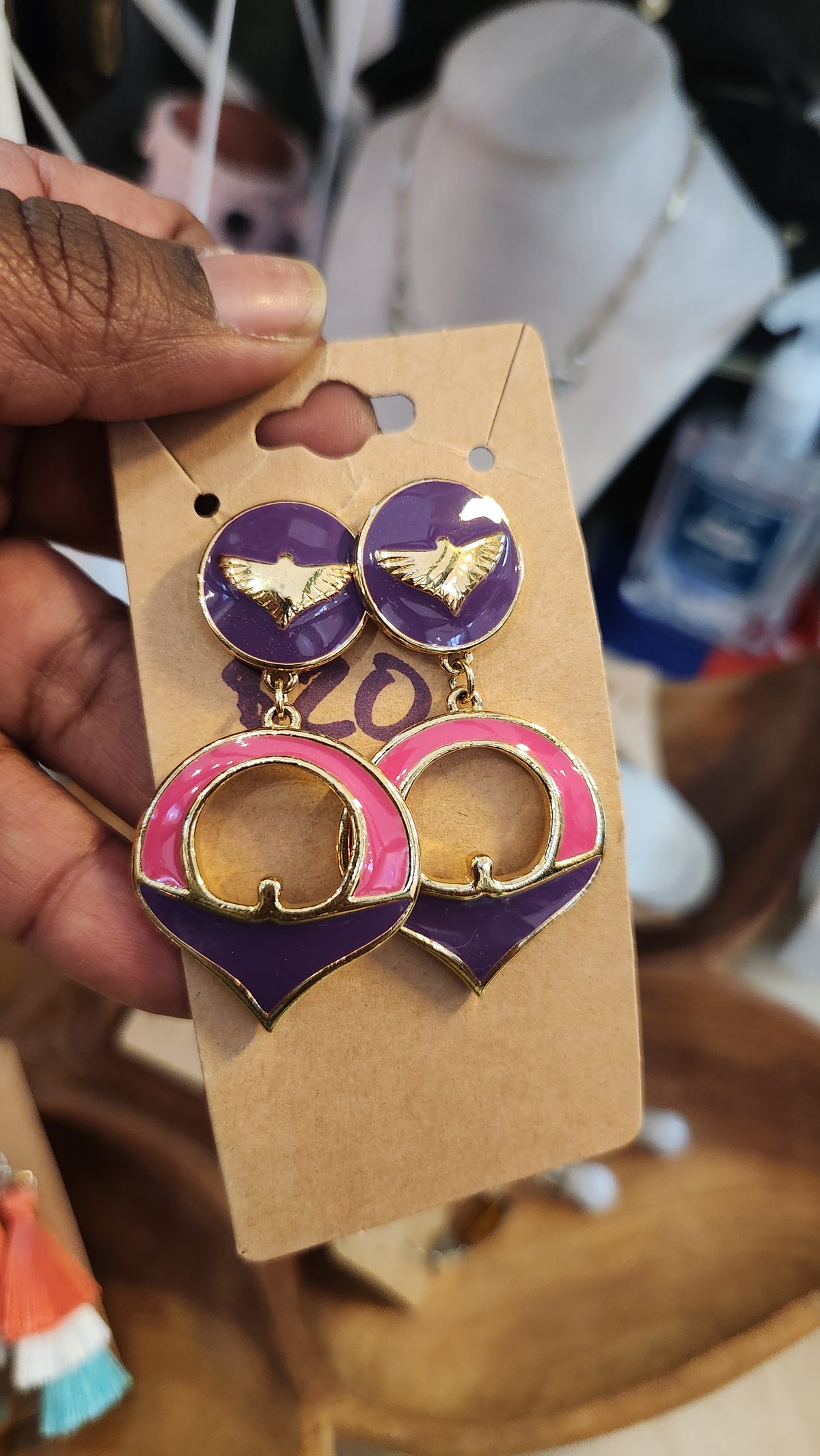 A pair of  vintage statement earrings The earrings feature a mix of purple, pink, and gold colors. 1A 980s Capezio enamel earrings.